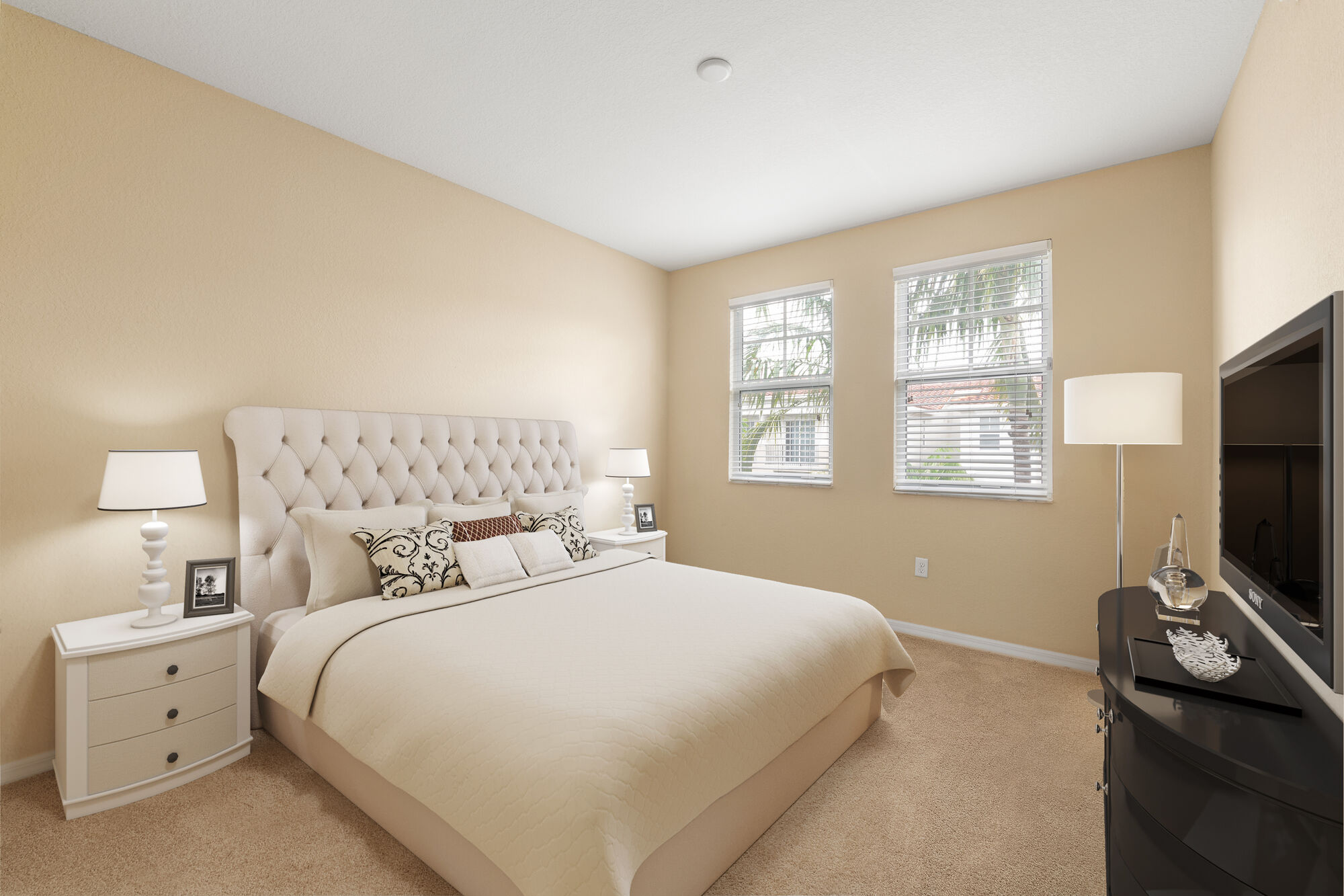 Carpeted bedroom with large windows